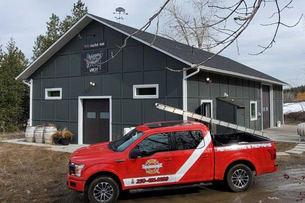 TI Roof red truck in front of Nagging Doubt Winery roofing project commercial